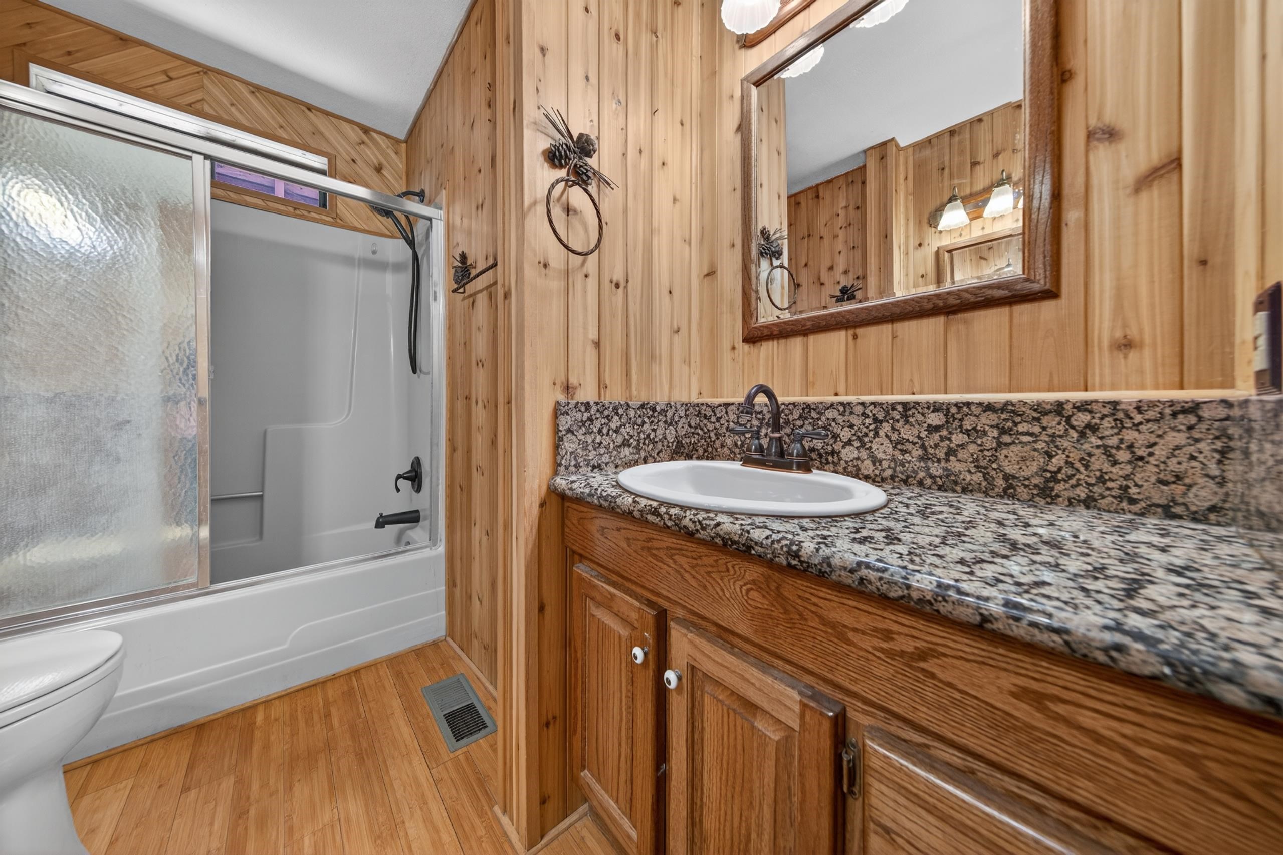 463-000 Moonlight Ranch Rd Westwood Road Susanville, CA 96130 - Photo 23 of 46 a bathroom with a granite countertop sink a mirror and a shower