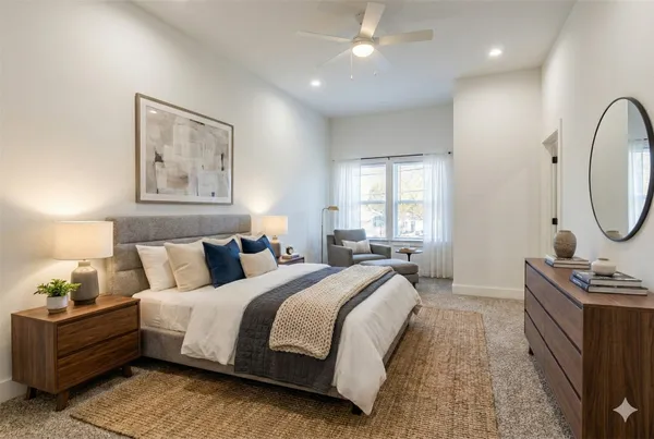 a bed room with a bed mirror and a window