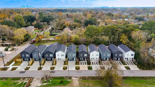 an aerial view of multiple houses with yard