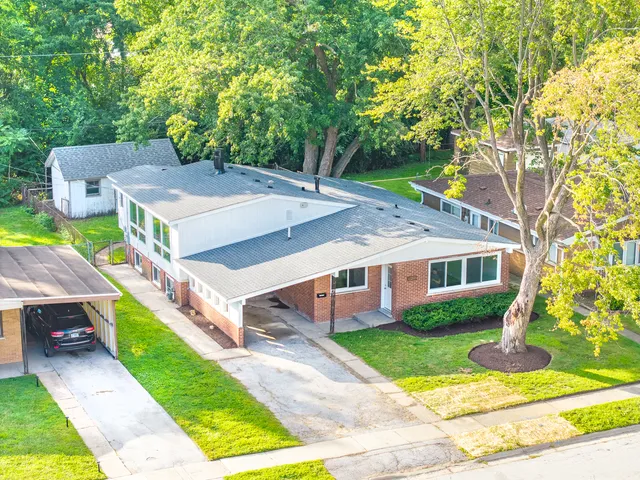 a aerial view of a house next to a yard