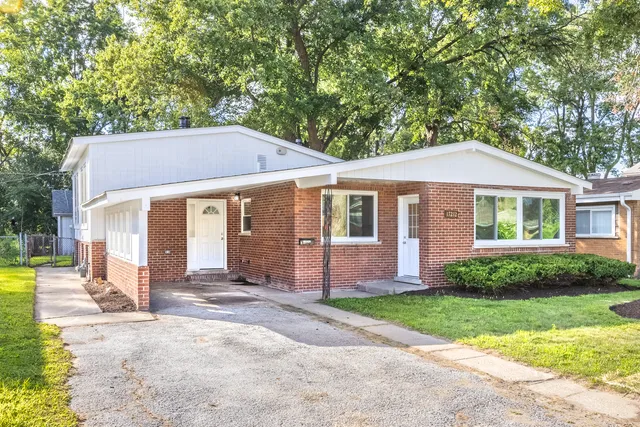 a front view of a house with a yard and porch