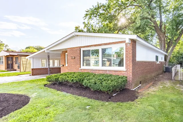 a view of a house with a yard and sitting area