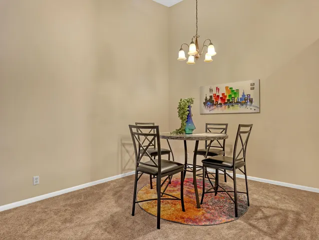 a view of a dining room with furniture and chandelier