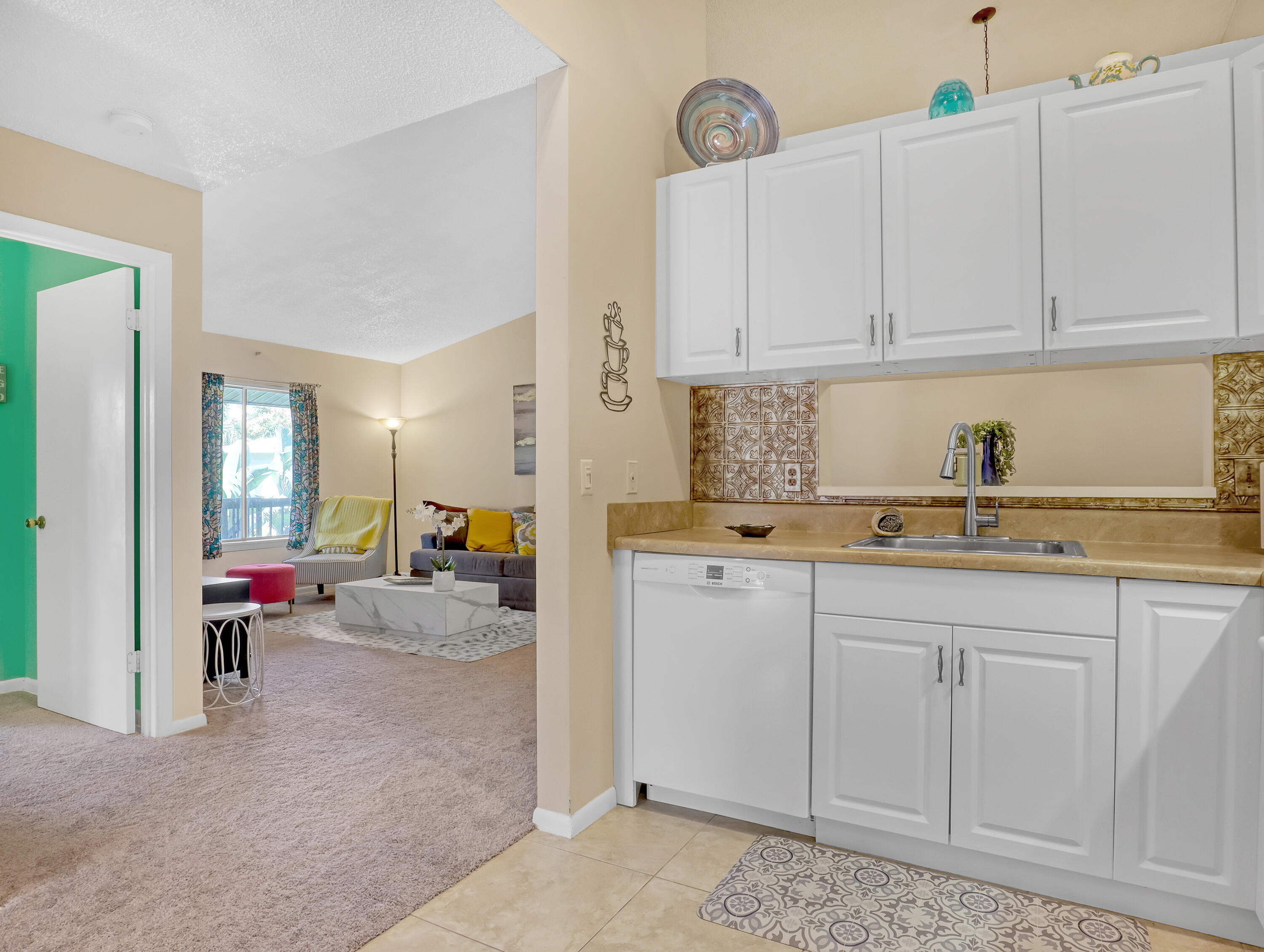6552 Chasewood Drive, Unit H Jupiter, FL 33458 - Photo 16 of 33 a kitchen with white cabinets and sink