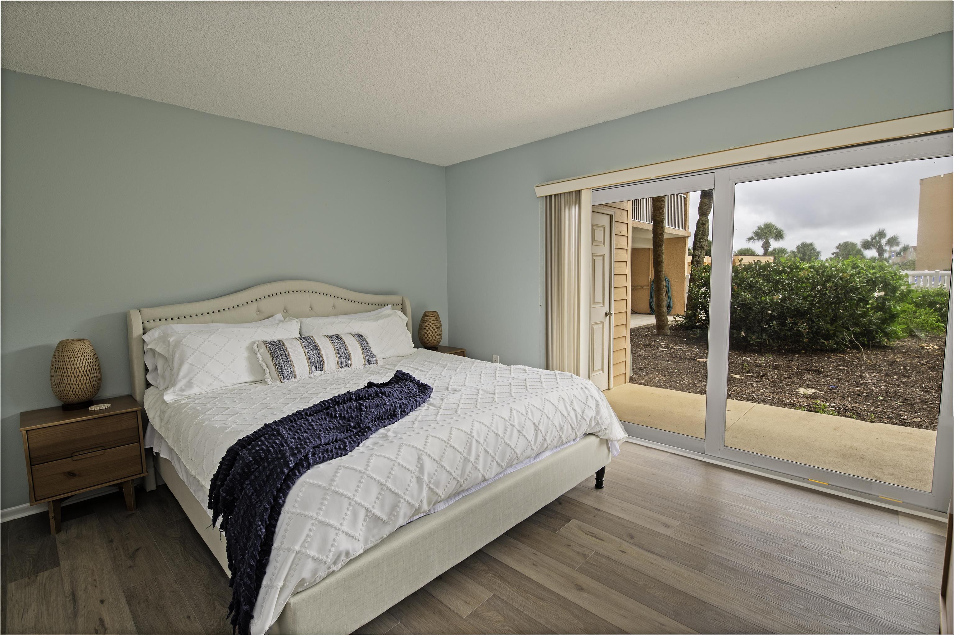 4 Ocean Trace Road, Unit 119 St. Augustine, FL 32080 - Photo 12 of 35 a bedroom with a bed and a large window