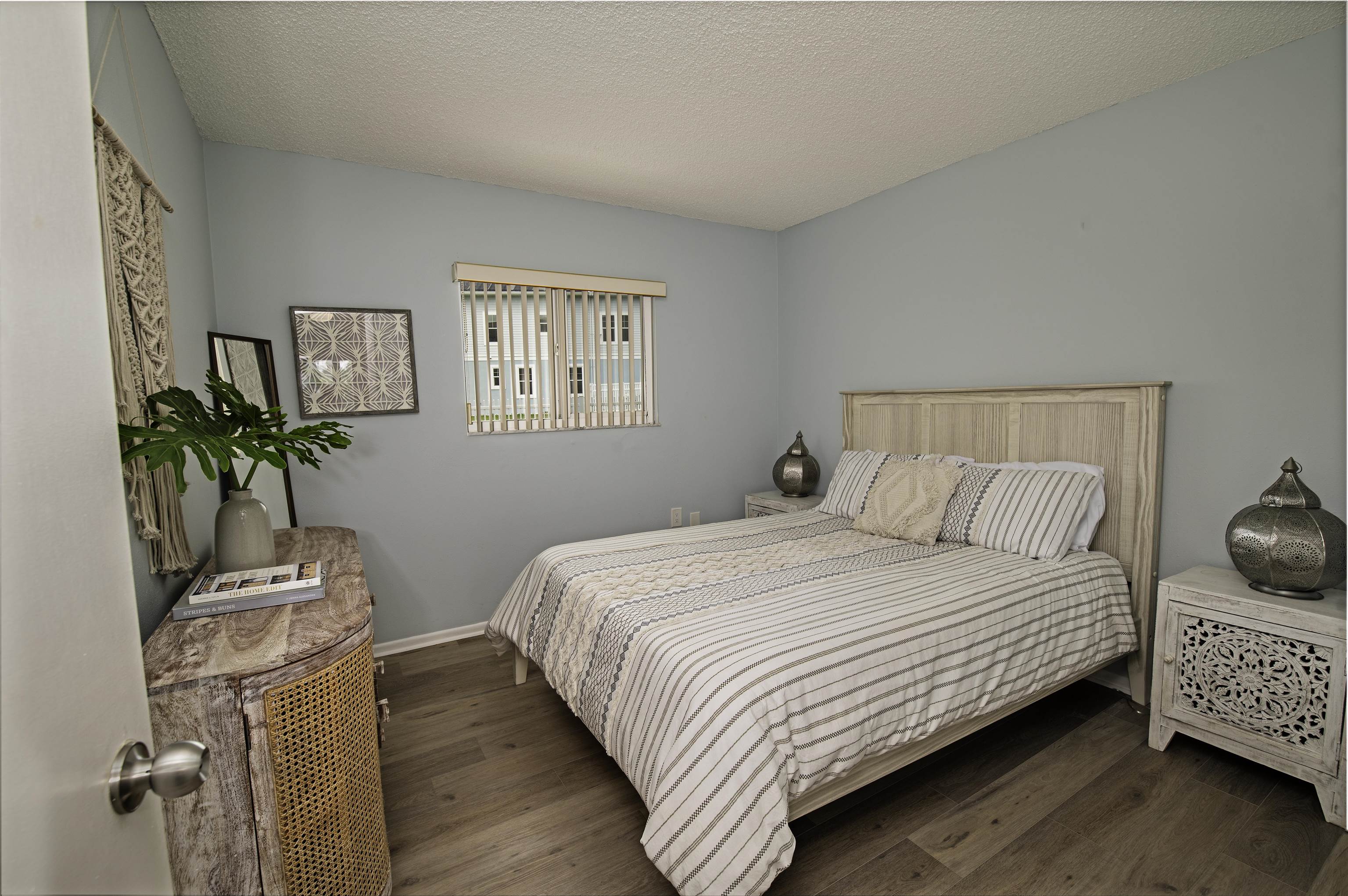 4 Ocean Trace Road, Unit 119 St. Augustine, FL 32080 - Photo 18 of 35 a bedroom with a bed and a potted plant