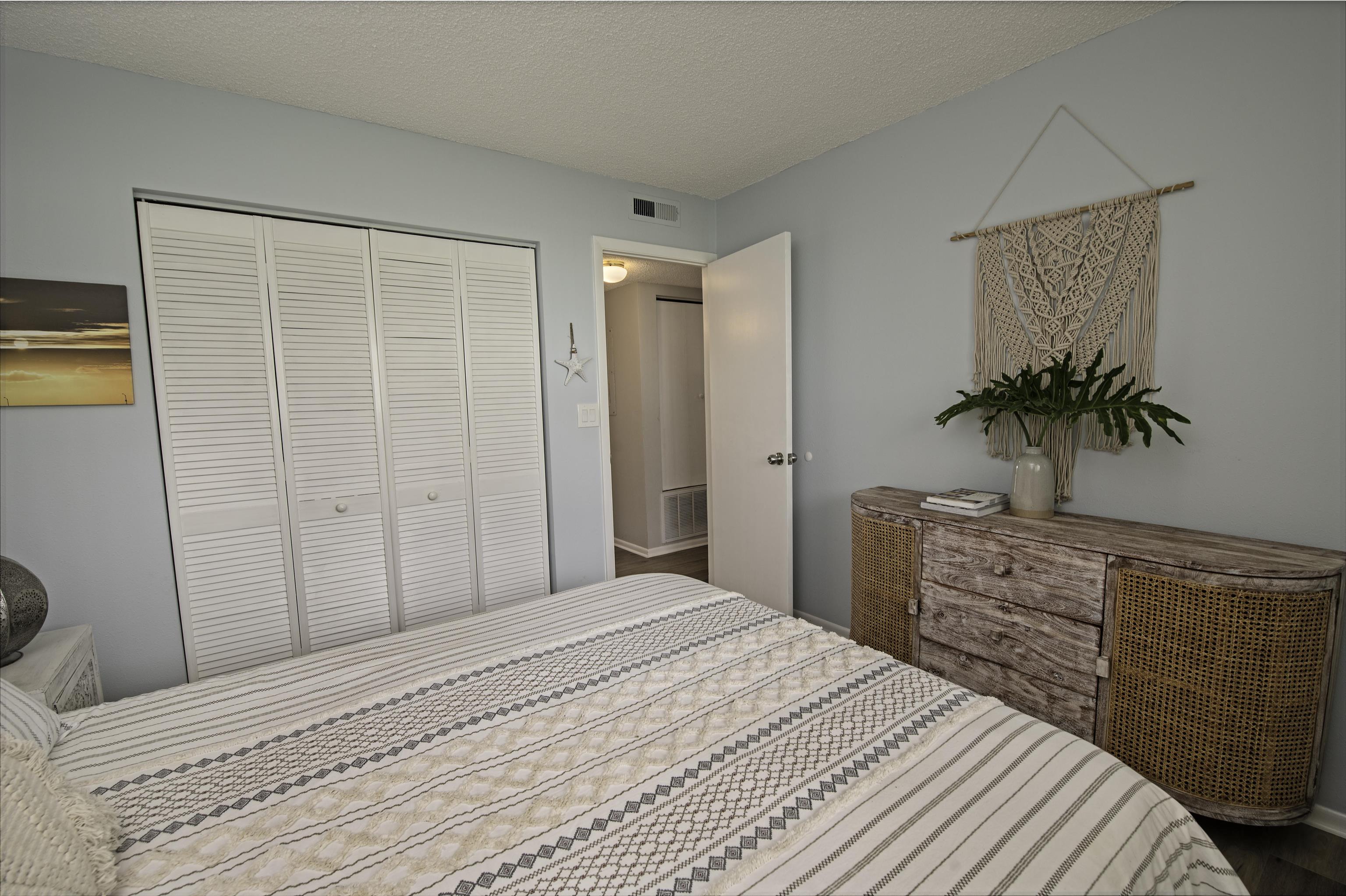 4 Ocean Trace Road, Unit 119 St. Augustine, FL 32080 - Photo 19 of 35 a bedroom with a bed and a potted plant