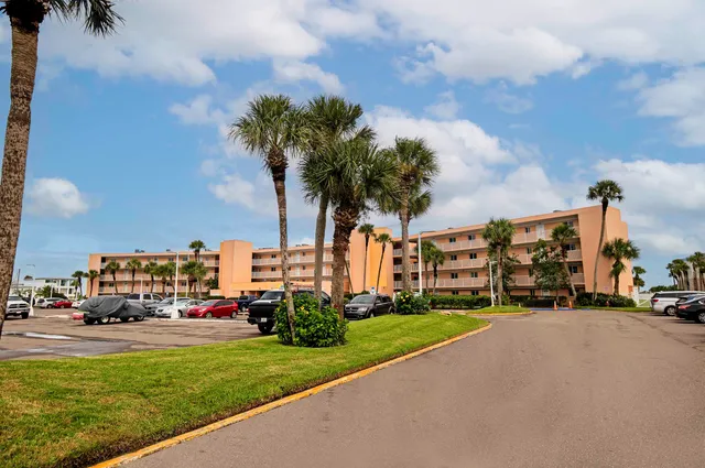 a car parked in front of a house with a big yard