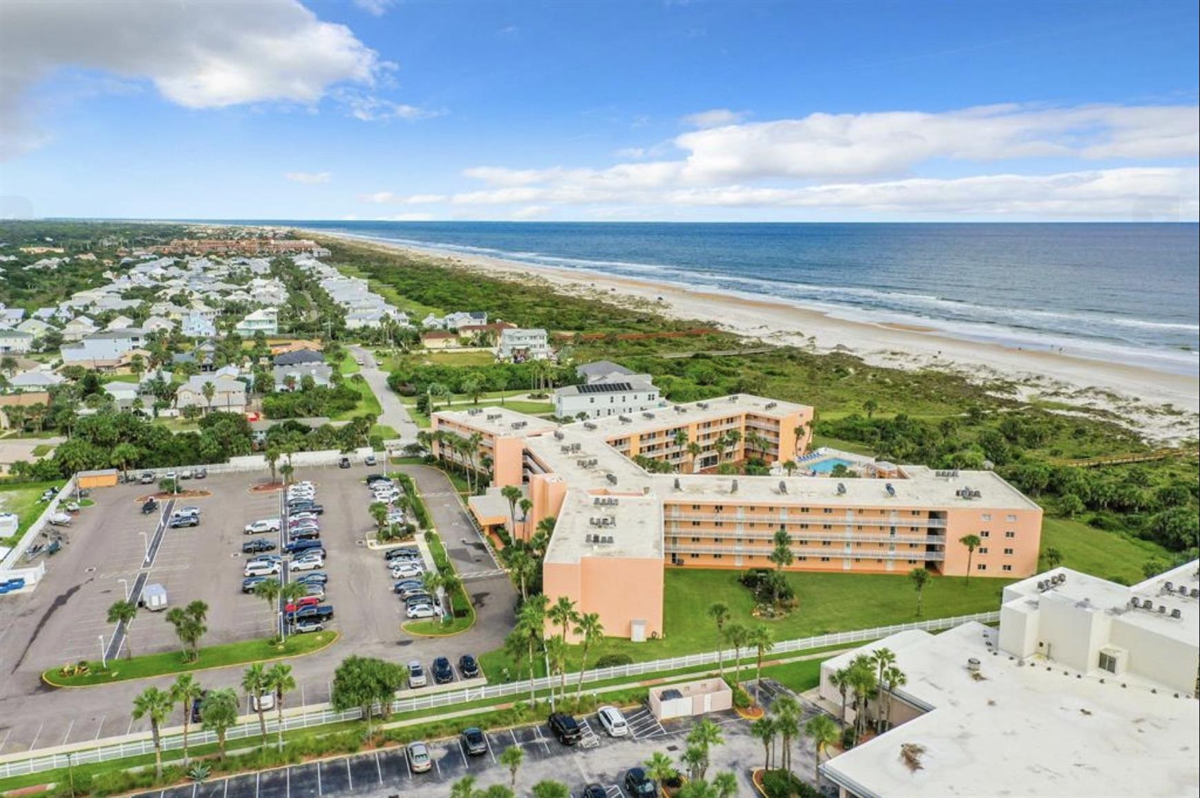 4 Ocean Trace Road, Unit 119 St. Augustine, FL 32080 - Photo 30 of 35 a view of building with an outdoor space and seating space