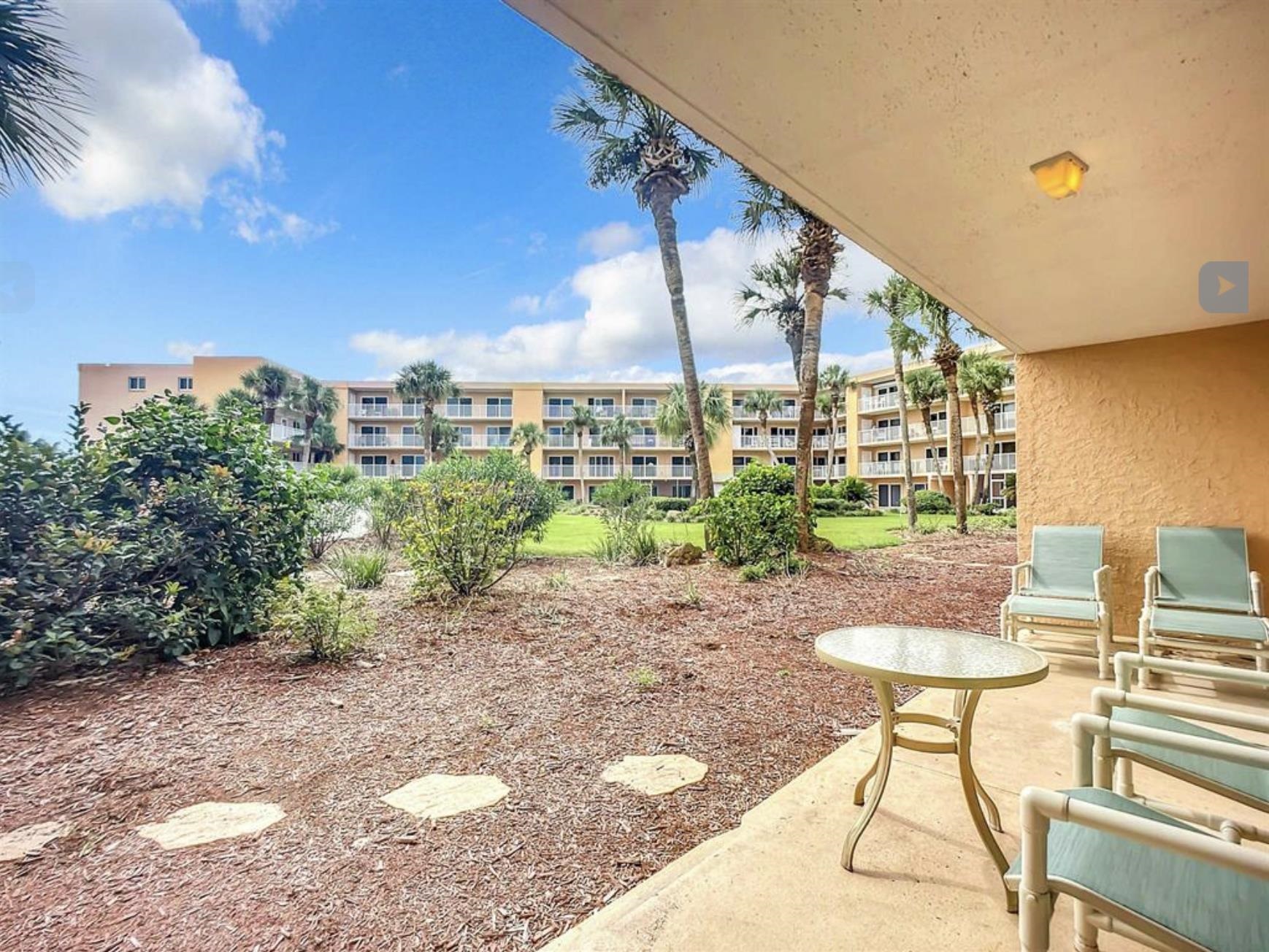 4 Ocean Trace Road, Unit 119 St. Augustine, FL 32080 - Photo 32 of 35 a view of a chairs and table in the patio
