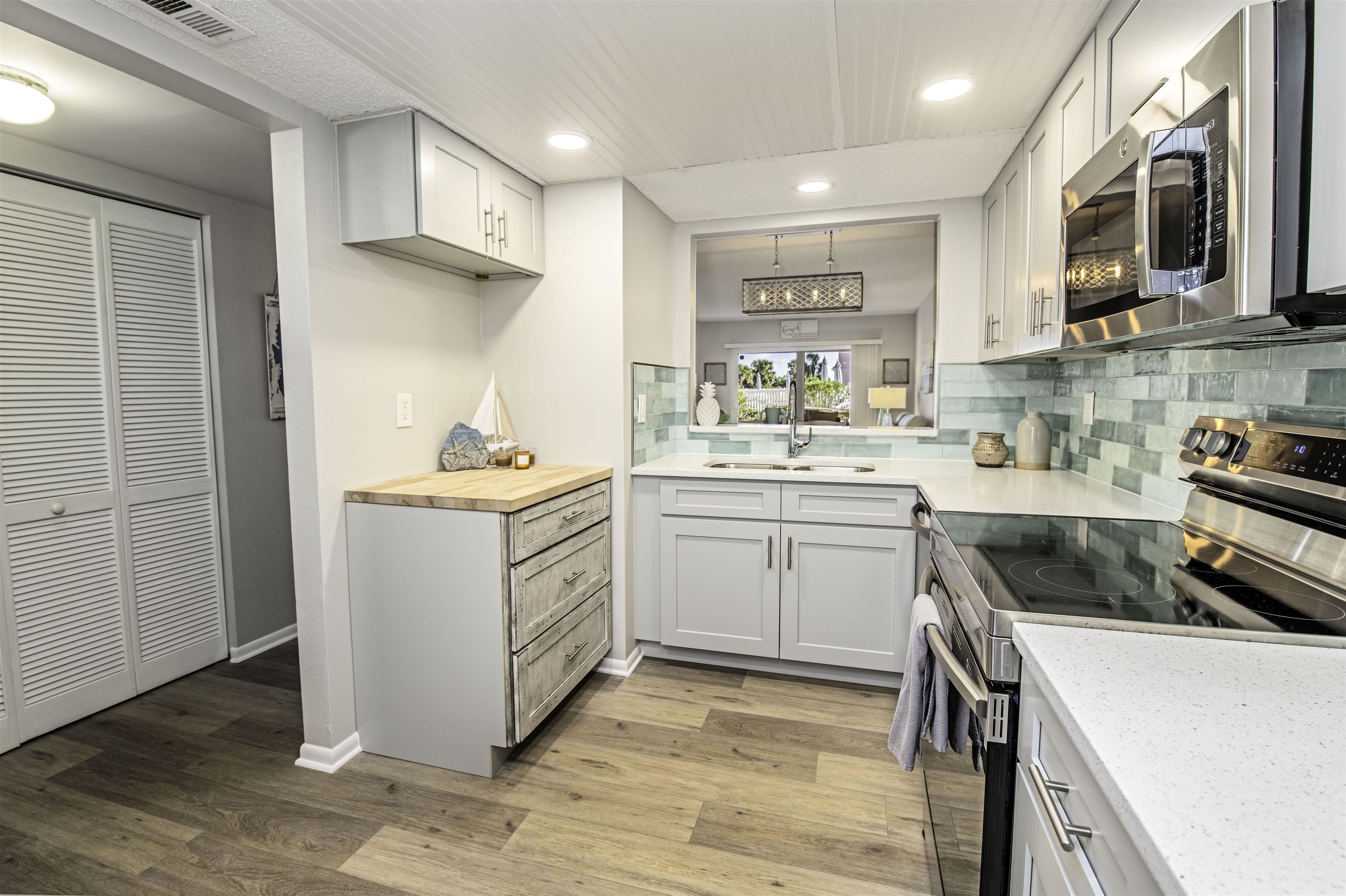 4 Ocean Trace Road, Unit 119 St. Augustine, FL 32080 - Photo 5 of 35 a kitchen with a sink stove and cabinets