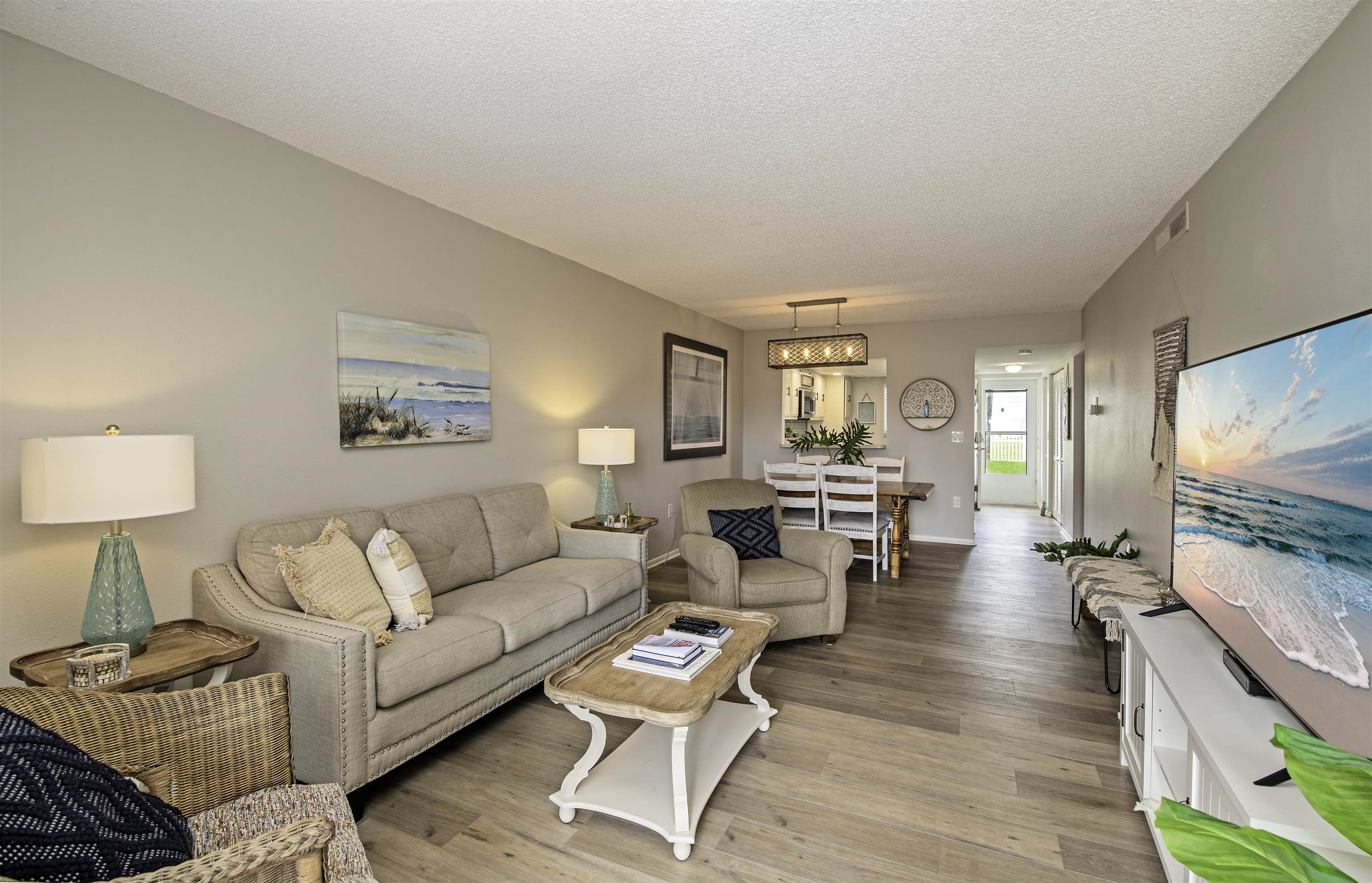 4 Ocean Trace Road, Unit 119 St. Augustine, FL 32080 - Photo 7 of 35 a living room with furniture and a flat screen tv