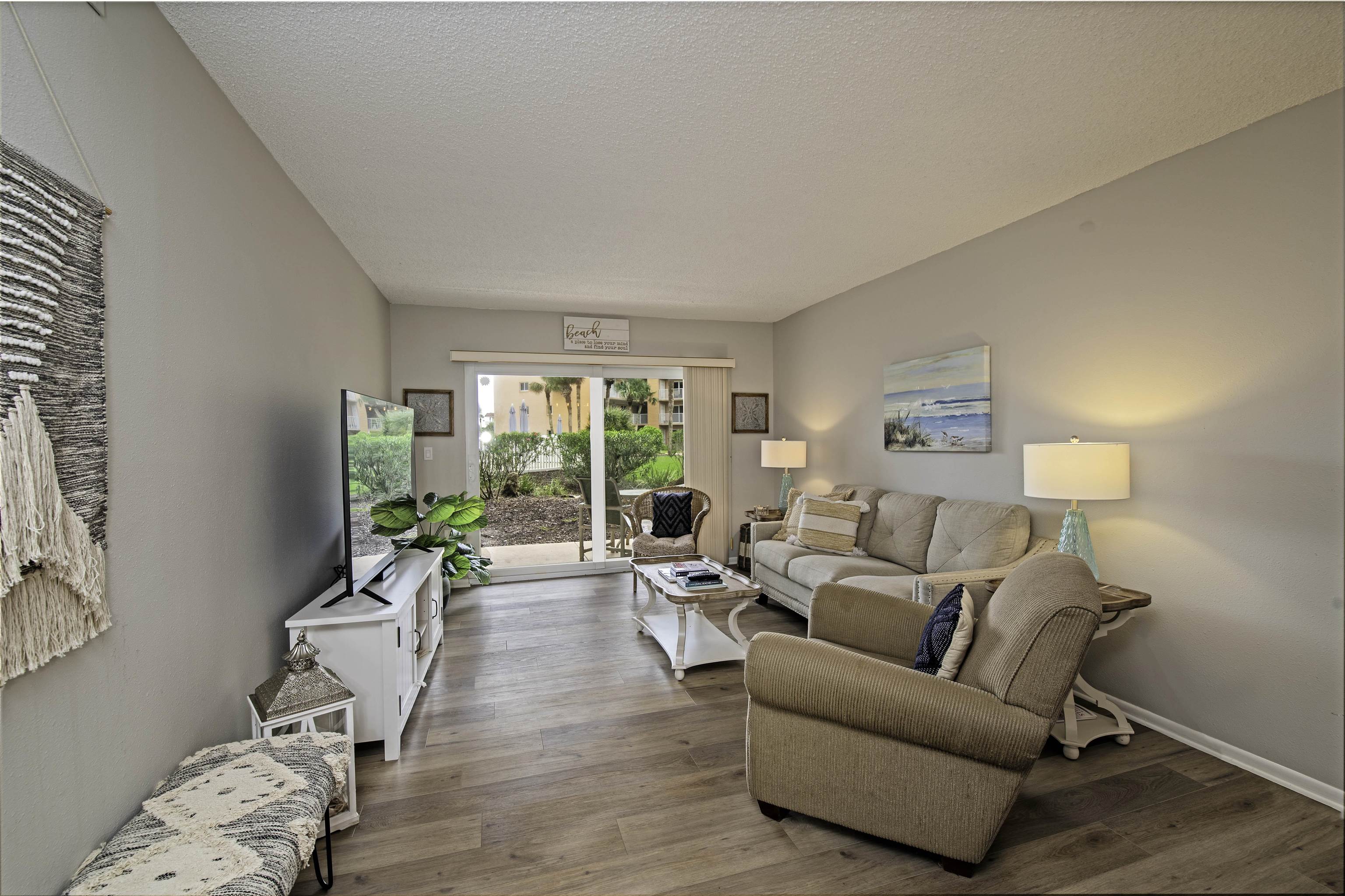 4 Ocean Trace Road, Unit 119 St. Augustine, FL 32080 - Photo 10 of 35 a living room with furniture and a large window