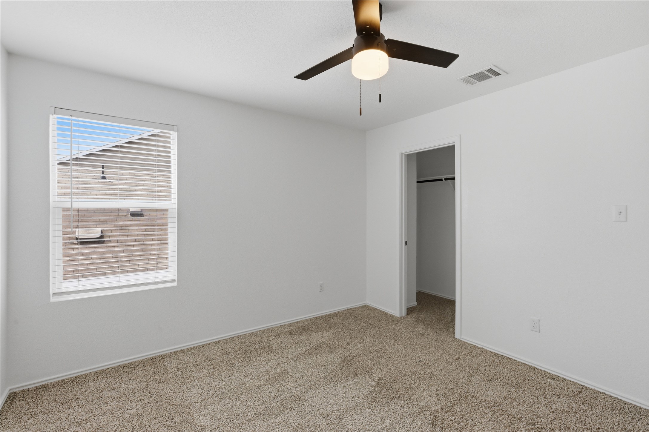 116 Night Riders Way Jarrell, TX 76537 - Photo 29 of 40 Carpeted room with a ceiling fan light fixture, a window with horizontal blinds, and a closet with a hanging rod
