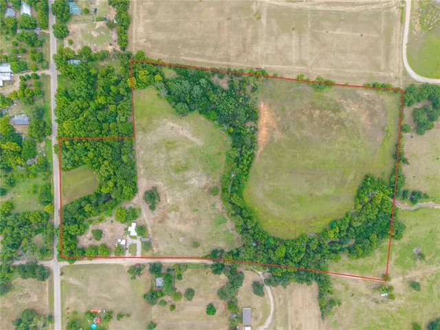 an aerial view of a residential houses with outdoor space and swimming pool