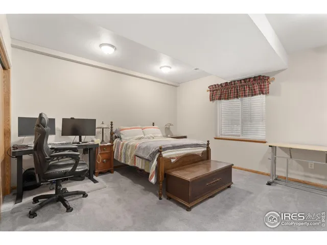 a bedroom with a bed and a desk