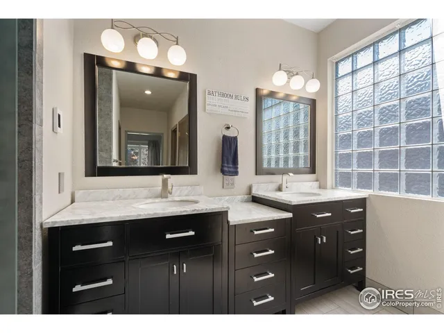 a bathroom with a double vanity sink and a mirror