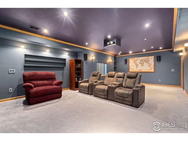 a living room with furniture and a projector screen