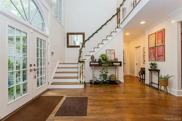 a view of entryway and hall with wooden floor