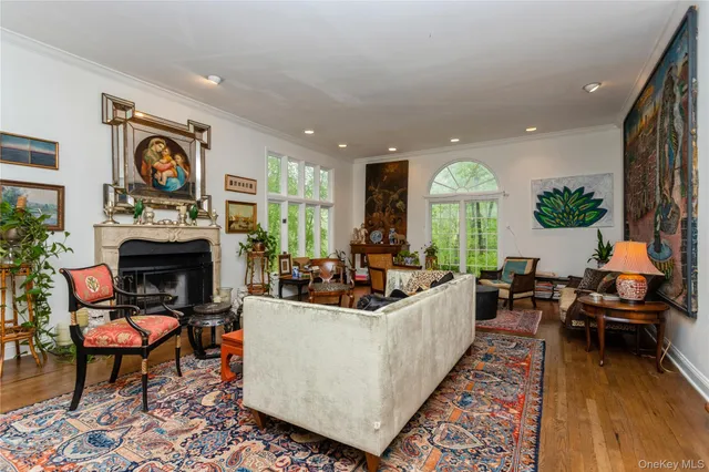 a living room with fireplace furniture and a large window
