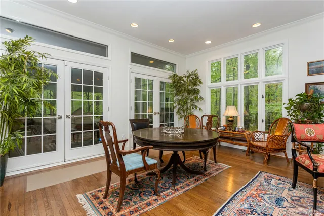 a view of a dining room with furniture window and wooden floor