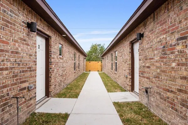 a view of pathway with building in the background