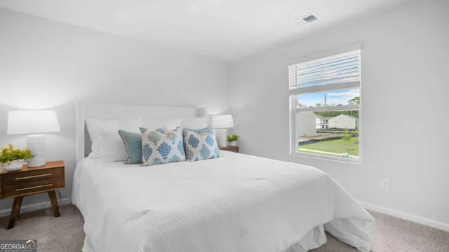 a bedroom with a bed and window