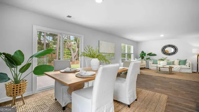 a living room with fireplace furniture and a large window