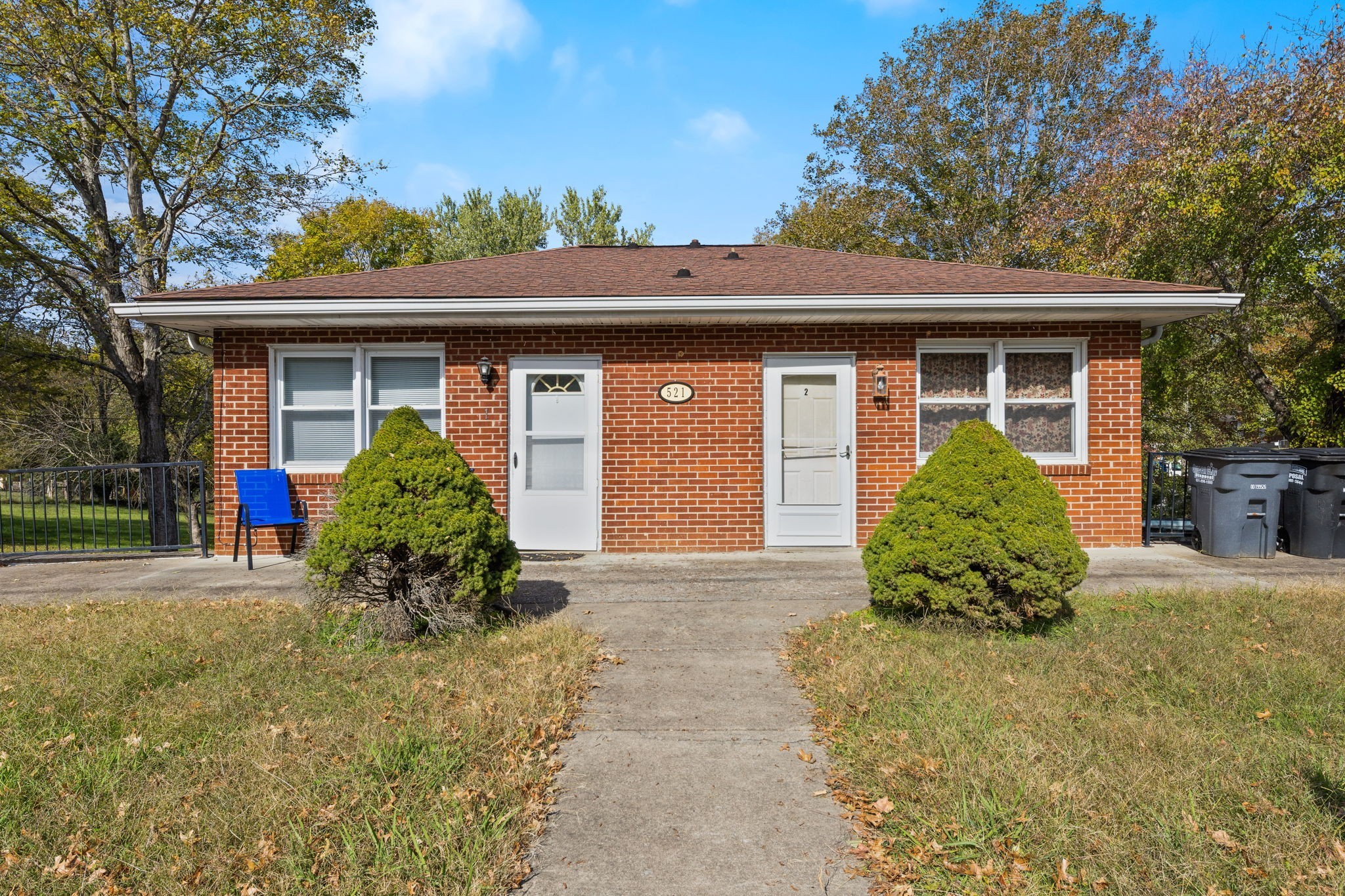 a front view of a house with a garden