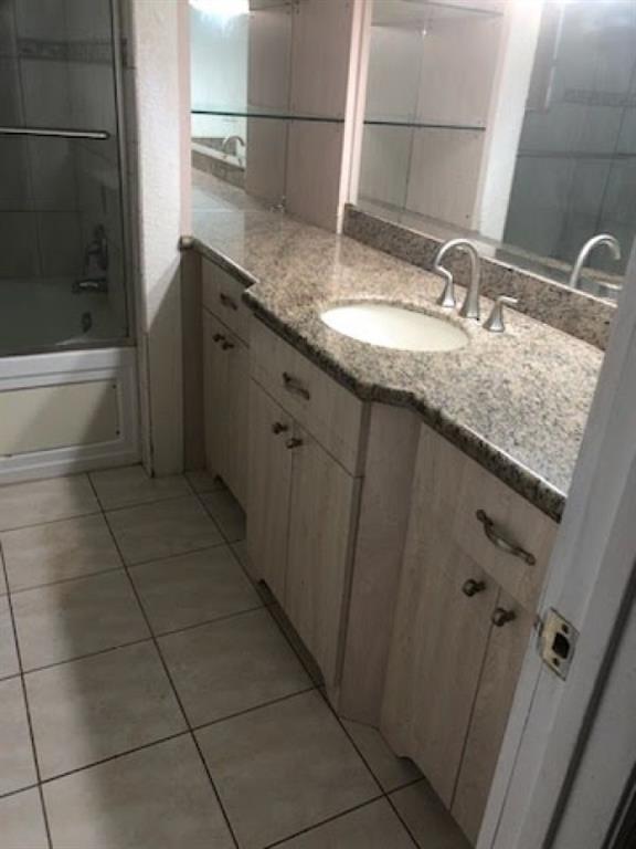 7101 Northwest 97th Avenue Tamarac, FL 33321 - Photo 21 of 23 a bathroom with a granite countertop sink a toilet and shower