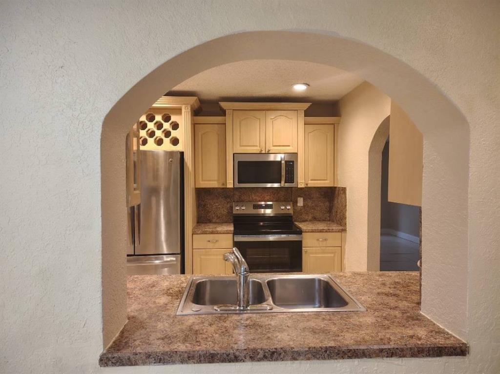 7101 Northwest 97th Avenue Tamarac, FL 33321 - Photo 8 of 23 a view of kitchen center island and stainless steel appliances