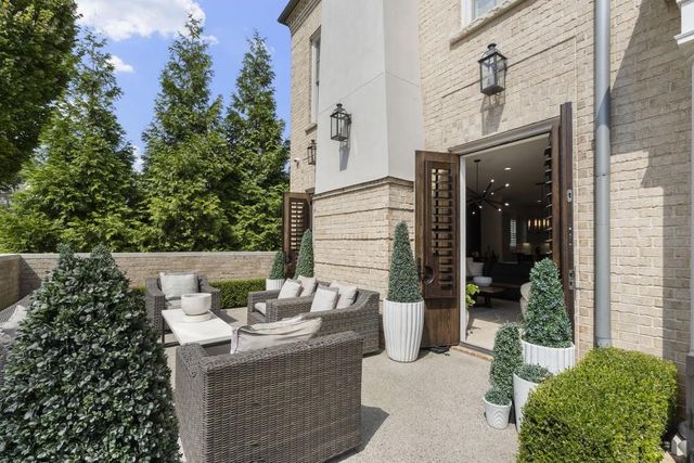 a view of a patio with table and chairs and potted plants