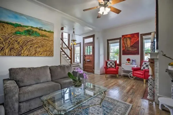 a living room with furniture flowerpot and a chandelier