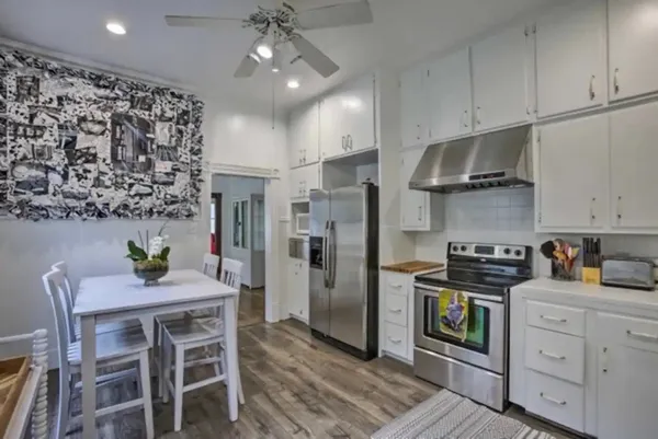 a kitchen with cabinets appliances a sink and a window