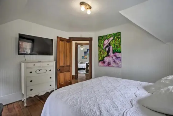 a bedroom with a bed and a couch