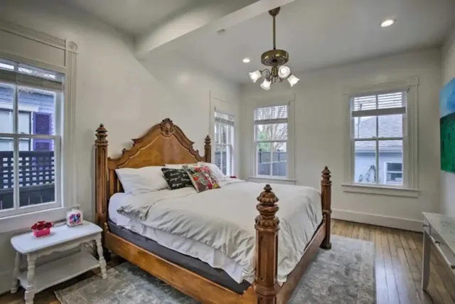 a bedroom with a bed and a chandelier