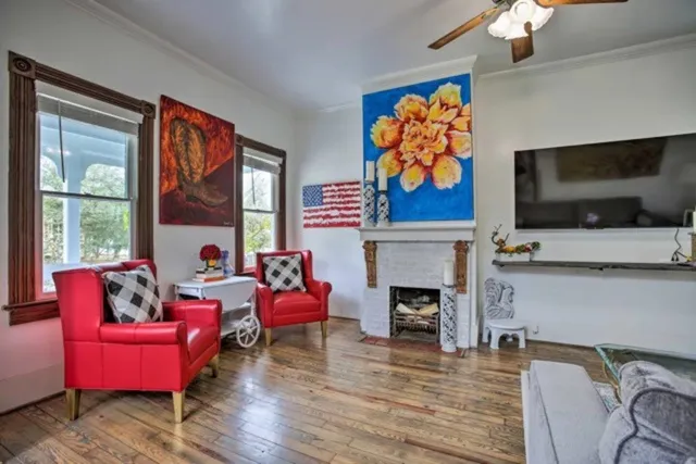 a living room with furniture a fireplace and a flat screen tv
