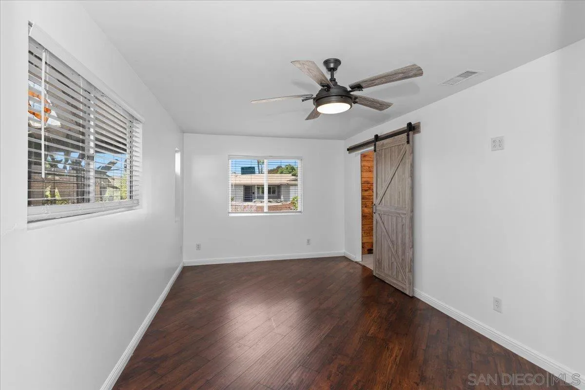 9307 Dalehurst Road Santee, CA 92071 - Photo 16 of 46 a view of empty room with wooden floor and fan
