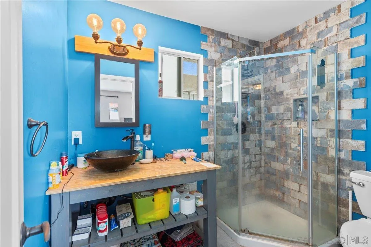 9307 Dalehurst Road Santee, CA 92071 - Photo 27 of 46 a bathroom with a sink a mirror and a shower