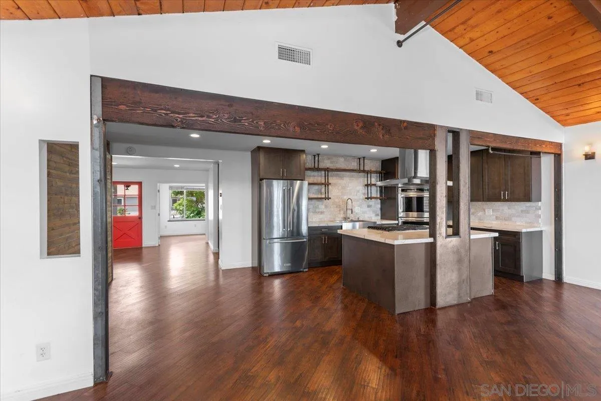 9307 Dalehurst Road Santee, CA 92071 - Photo 5 of 46 a kitchen with stainless steel appliances kitchen island wooden cabinets and granite counter tops