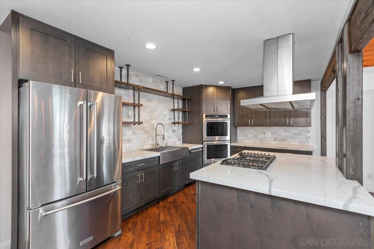 9307 Dalehurst Road Santee, CA 92071 - Photo 7 of 46 a kitchen with stainless steel appliances a refrigerator and a stove top oven