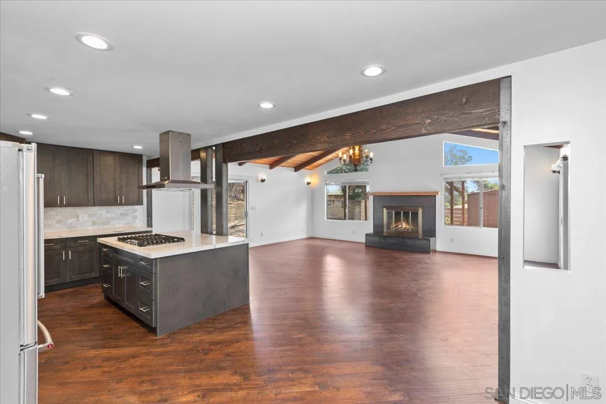 9307 Dalehurst Road Santee, CA 92071 - Photo 9 of 46 a kitchen with stainless steel appliances granite countertop a stove and a wooden floors