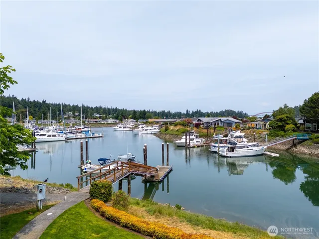 a view of a lake with boats and trees in the background
