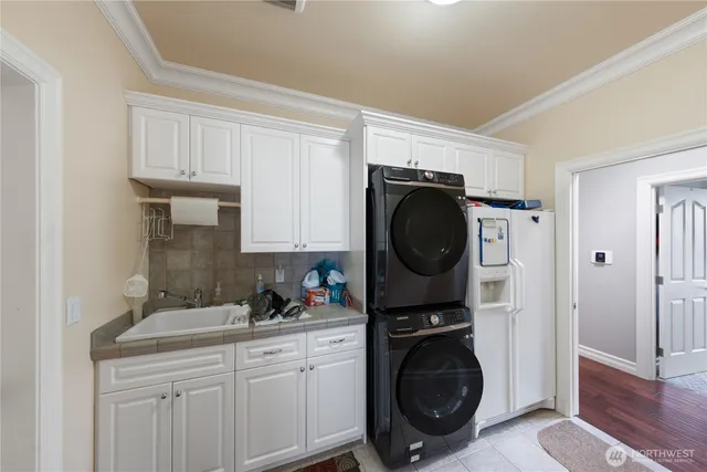 a utility room with sink dryer and washer
