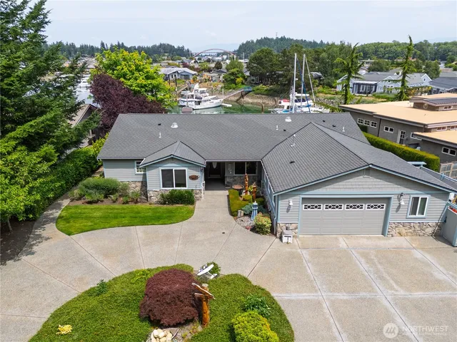 an aerial view of a house with a garden and large trees