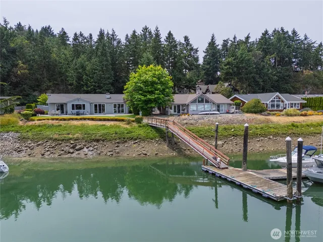 a view of a house with pool and a yard