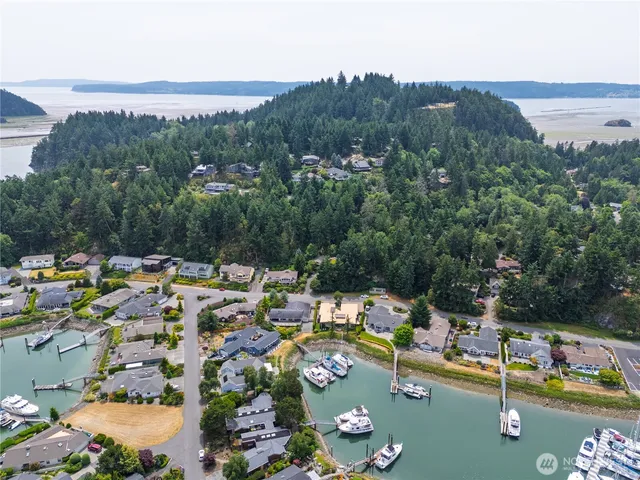 an aerial view of a swimming pool with outdoor seating