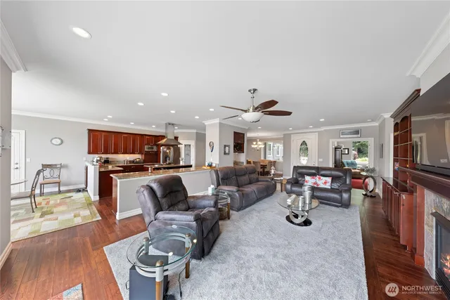 a living room with furniture kitchen view and a large window