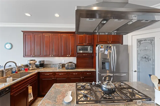 a kitchen with a sink stove and cabinets