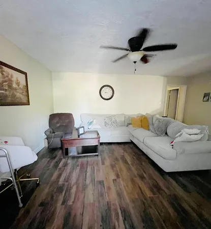 a living room with furniture and wooden floor